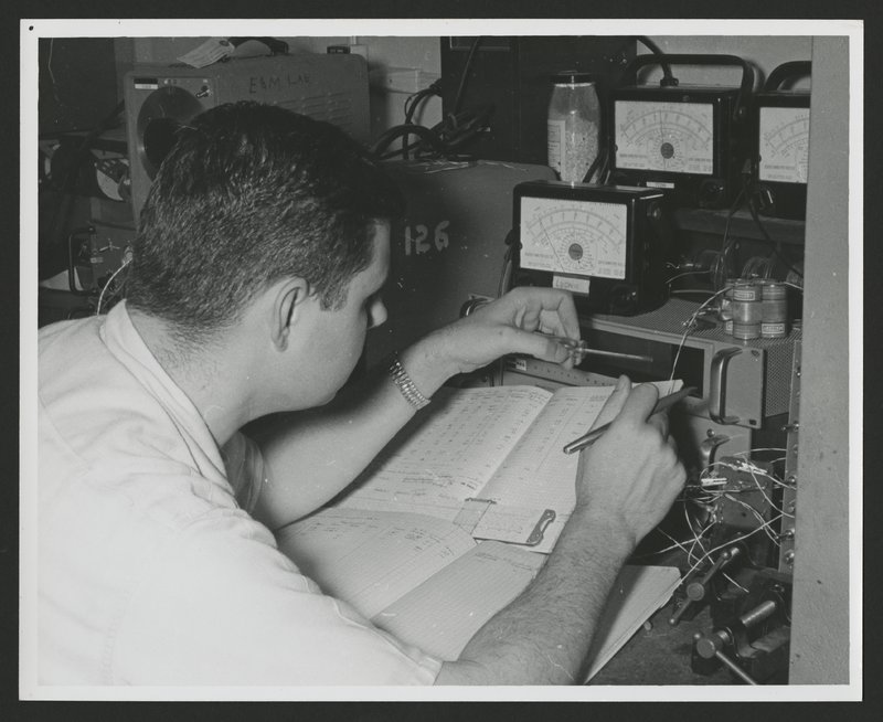 George Ludwig recording data tape playback into his personal notebook