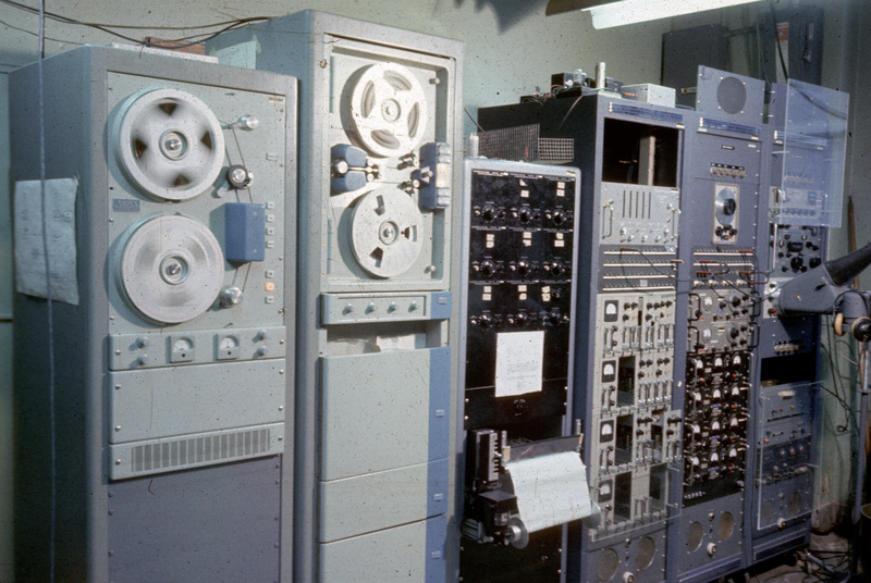 Station recording satellite data onto reel-to-reel magnetic tapes while the plotter prints the data onto long pieces of graph paper