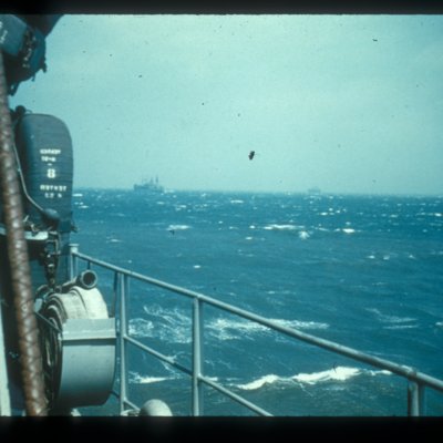 slide of several expediation ships on water, photo taken from bow of ship