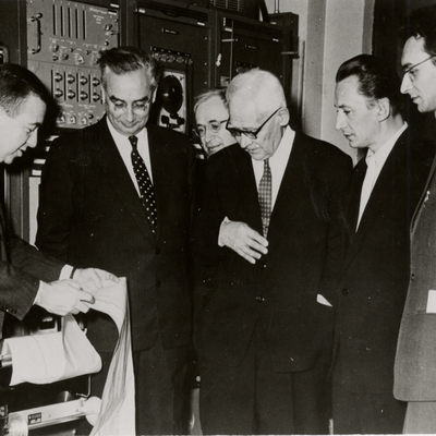 James Van Allen showing tour group the print out of Explorer audio data tapes