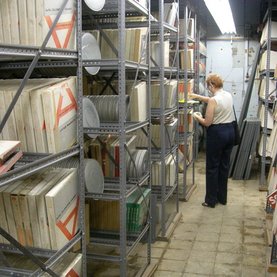 University of Iowa Head of Preservation evaluating data tape conditions in the basement of MacLean Hall