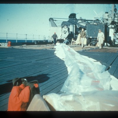 Men stretching the rackoon balloon prior to filling and launch