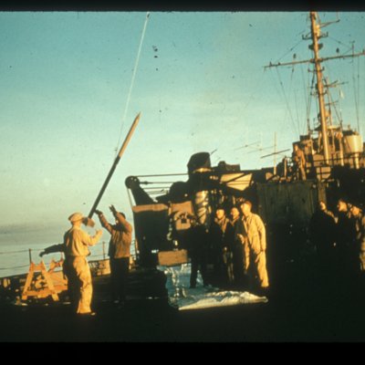 Five men watch as they launch a rackoon rocket